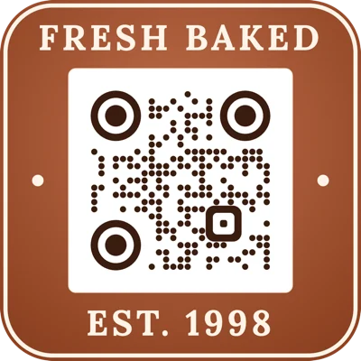 A terracotta rounded badge with “Fresh baked” above the code and “Est. 1998” below